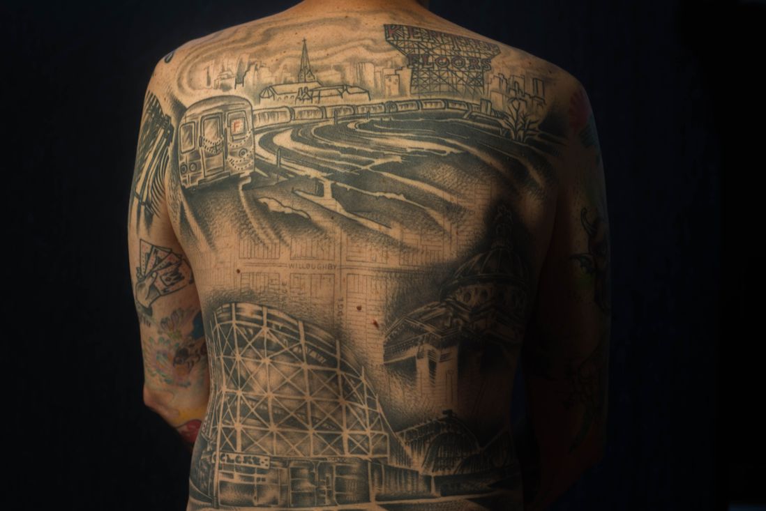 David Dyte, originally from Melbourne, got a back piece with the F train, Kentile Floor sign, Cyclone roller coaster and the Williamsburg bank building. The piece, tattooed by Kati Vaughn, also includes historical city maps of his neighborhood, Downtown Brooklyn.<br>